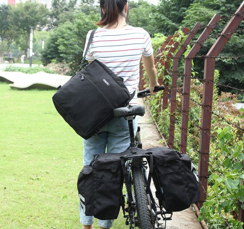 LANKELEISI Bike 3-in-1 trunk bag with double side compartments mounted on a bicycle rear rack for storage.